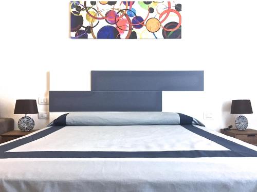 a bedroom with a large bed with a painting on the wall at Residenza Santa Lù B&B in Naples