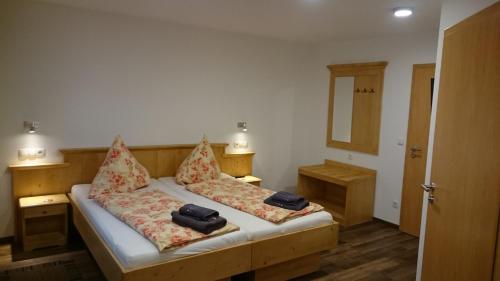 a small bedroom with two beds with pillows at Mühldorfer Hof in Altötting