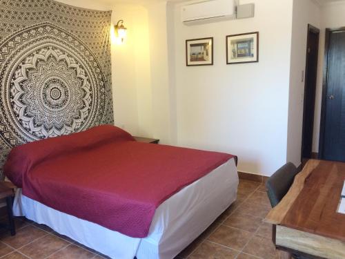 a hotel room with a bed and a wall at Easy Inn Hotel in Belize City