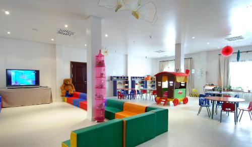 a room with a playroom with a table and chairs at Vincci Selección La Plantación del Sur in Adeje