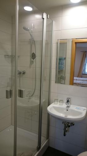a bathroom with a shower and a sink at Mühldorfer Hof in Altötting
