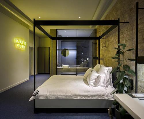 a bedroom with a large bed with a window at BURSA Hotel Kyiv in Kyiv