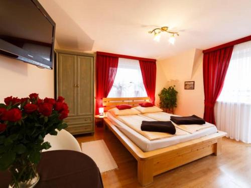 a bedroom with a large bed and a large window at Giencyno Koncina Poronin in Poronin