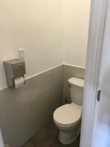 a bathroom with a toilet and a toilet paper dispenser at The Bartlett Hotel and Guesthouse in San Francisco