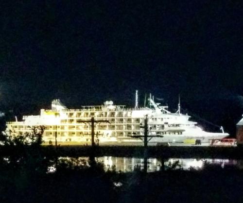 a large white cruise ship in the water at night at Braeside Country Inn in Pictou