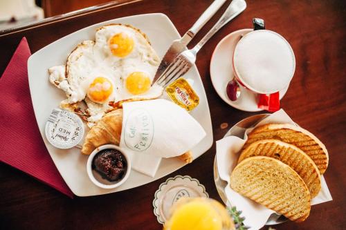 a plate of eggs and bread and a cup of milk at Apartment Petra IV in Dubrovnik