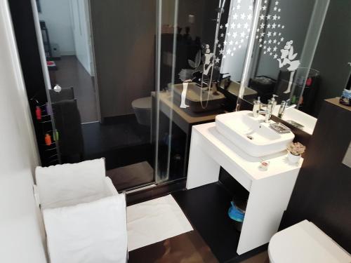 een badkamer met een witte wastafel en een spiegel bij Home4you in Lissabon