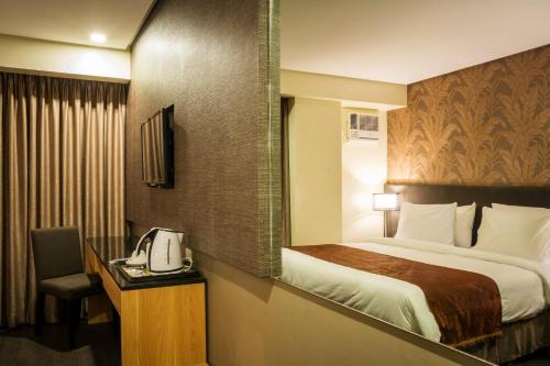 Postel nebo postele na pokoji v ubytování GT Hotel Iloilo