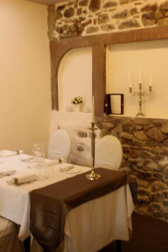 a dining room with a table and a mirror at Die Reichsstadt - Hotel Spa und Restaurant in Gengenbach