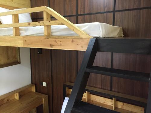 a bunk bed in a room with a ladder at Villa Eden Paradise in Ella