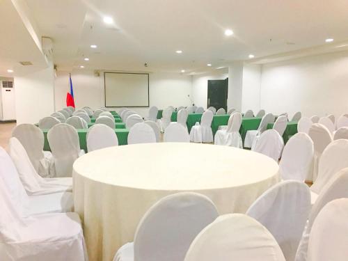 a conference room with a white table and chairs at Forest Crest Nature Hotel and Resort Powered by ASTON in Nasugbu