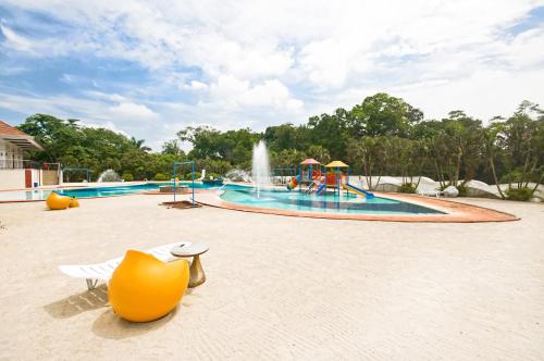 a water park with a pool with a fountain at Forest Crest Nature Hotel and Resort Powered by ASTON in Nasugbu