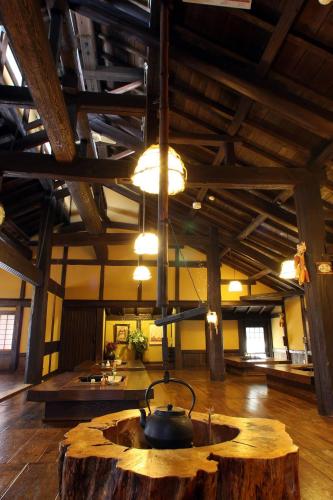 a room with a tea kettle on top of a wooden table at Syukubo Aso in Aso