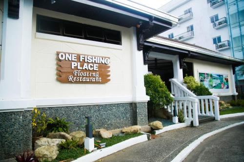 a one fishing place sign on the side of a building at Forest Crest Nature Hotel and Resort Powered by ASTON in Nasugbu