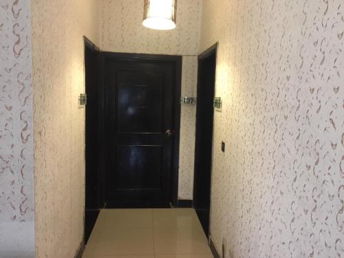a hallway with a black door in a room at Star House in Islamabad