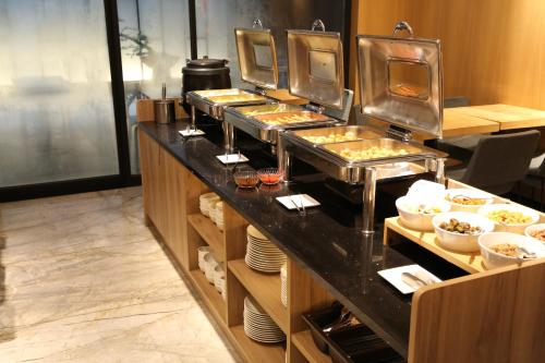 a buffet line in a restaurant with food at Miller Inn in Taichung