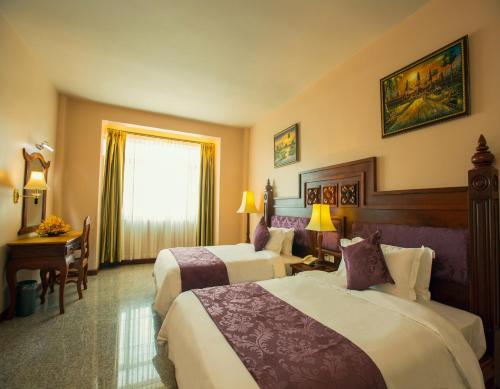 Ένα ή περισσότερα κρεβάτια σε δωμάτιο στο Phnom Penh Era Hotel