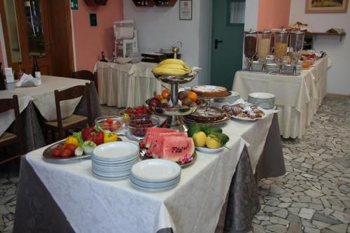 a table with a buffet of fruit and food on it at Hotel Villa Ombrosa in Portoferraio