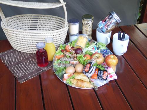 a plate of food on a table with a salad at Luxury Tented Village @ Urban Glamping in St Lucia