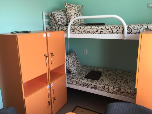 a small room with a bunk bed and a desk at Karavella in Mykolaiv
