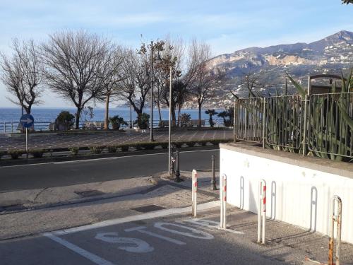 an empty road with a bus sign on the side of the road at Maiori Apartment by Marcel in Maiori