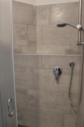 a shower in a bathroom with a glass door at Ricci Rooms in Genova