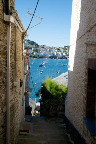 an alley with a view of a harbor with boats at Polmarine in Polruan