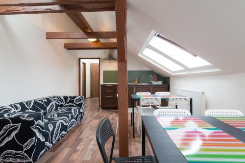 a dining room with tables and chairs and a skylight at Easy Housing in Prague