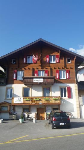 a large building with a car parked in front of it at B&B Eischoll in Eischoll