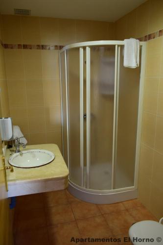 a bathroom with a shower and a sink at Apartamentos Horno y Casa De Dulce in Purullena