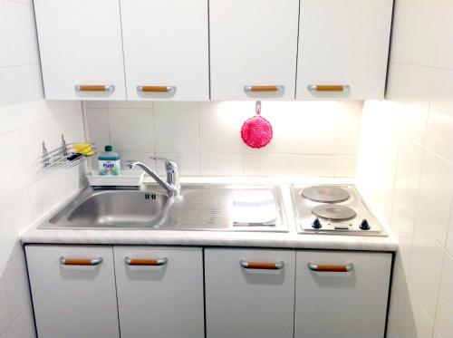 a kitchen with a sink and a stove at Mini Chic Downtown in Bologna