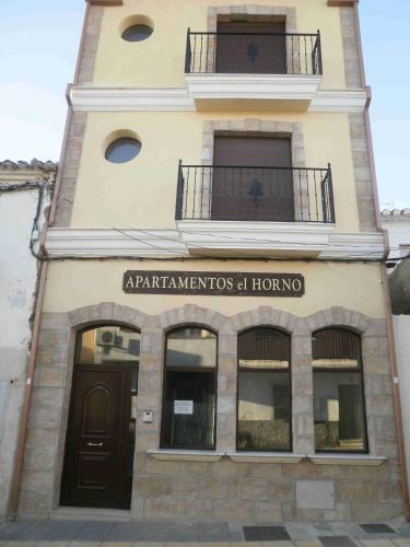 a building with a sign that reads departments at home at Apartamentos Horno y Casa De Dulce in Purullena