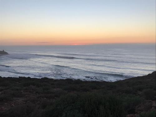 a view of the ocean at sunset at My Home Mirelft in Mirleft