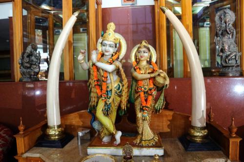 a statue of two women standing next to swords at Mayura Residency in Guruvāyūr