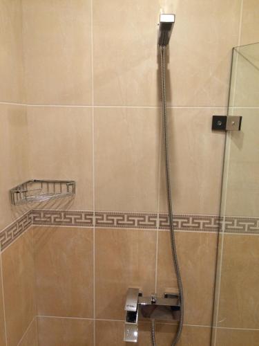 a shower with a hose in a bathroom at Luxury Two Bedroom Flat in Blagoevgrad