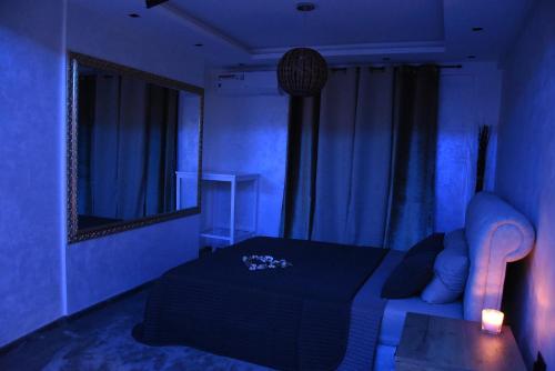 a blue room with a couch and a mirror at Central Business Apartments Jacuzzi in Belgrade