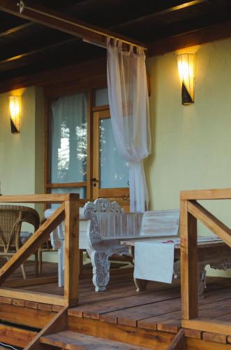 a room with a bed on a wooden deck at ALEHUE Casa de Montaña in Villa La Angostura