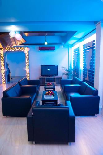 a living room with couches and a blue light at Restinn Hotel in Maulvi Bāzār