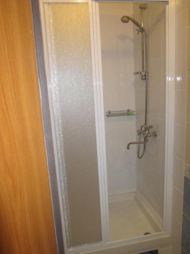 a shower with a glass door in a bathroom at Yaroslav Hostel in Kyiv