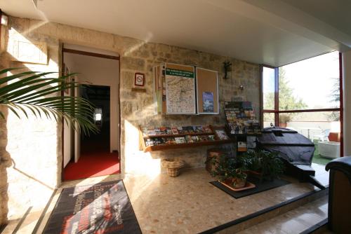 a shop with a counter in a stone wall at Logis Auberge La Diege in Capdenac-Gare