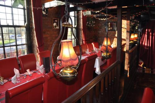 a row of red seats on a train with lights at The Roundabout Hotel in Fareham