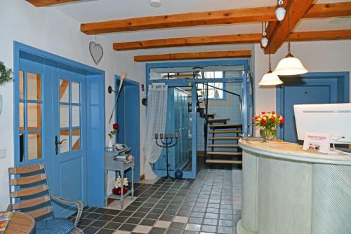 a room with a blue door and a staircase at Pension zum Brauhaus in Stralsund