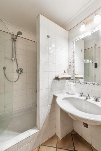 a white bathroom with a sink and a shower at Weekend a Napoli in Naples