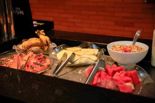 a table with a bunch of food on a counter at Hotel Emacite Flex in Mafra
