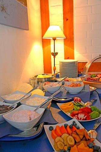 a table topped with bowls and plates of food at Pension zum Brauhaus in Stralsund