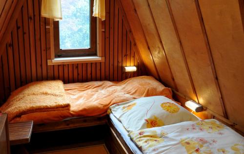 ein kleines Zimmer mit 2 Betten und einem Fenster in der Unterkunft Finnhütte von Mai bis September in Wittenbeck
