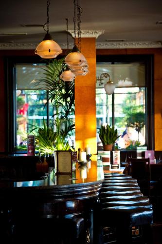 a bar in a restaurant with a table and chairs at Riverbank House Hotel in Wexford