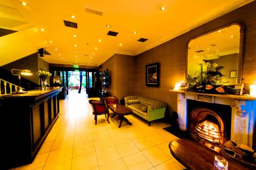 a living room with a fireplace and a couch at Riverbank House Hotel in Wexford