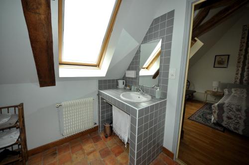 a bathroom with a sink and a window at Grange du Plessis in Segré