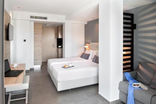 a hotel room with a white bed and a desk at Gkeea Boutique Hotel in Ierissos